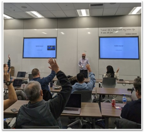 Image of WWT and NVIDIA experts at WWT's Advanced Technology Center. Participants are sitting at desks in a conference room.